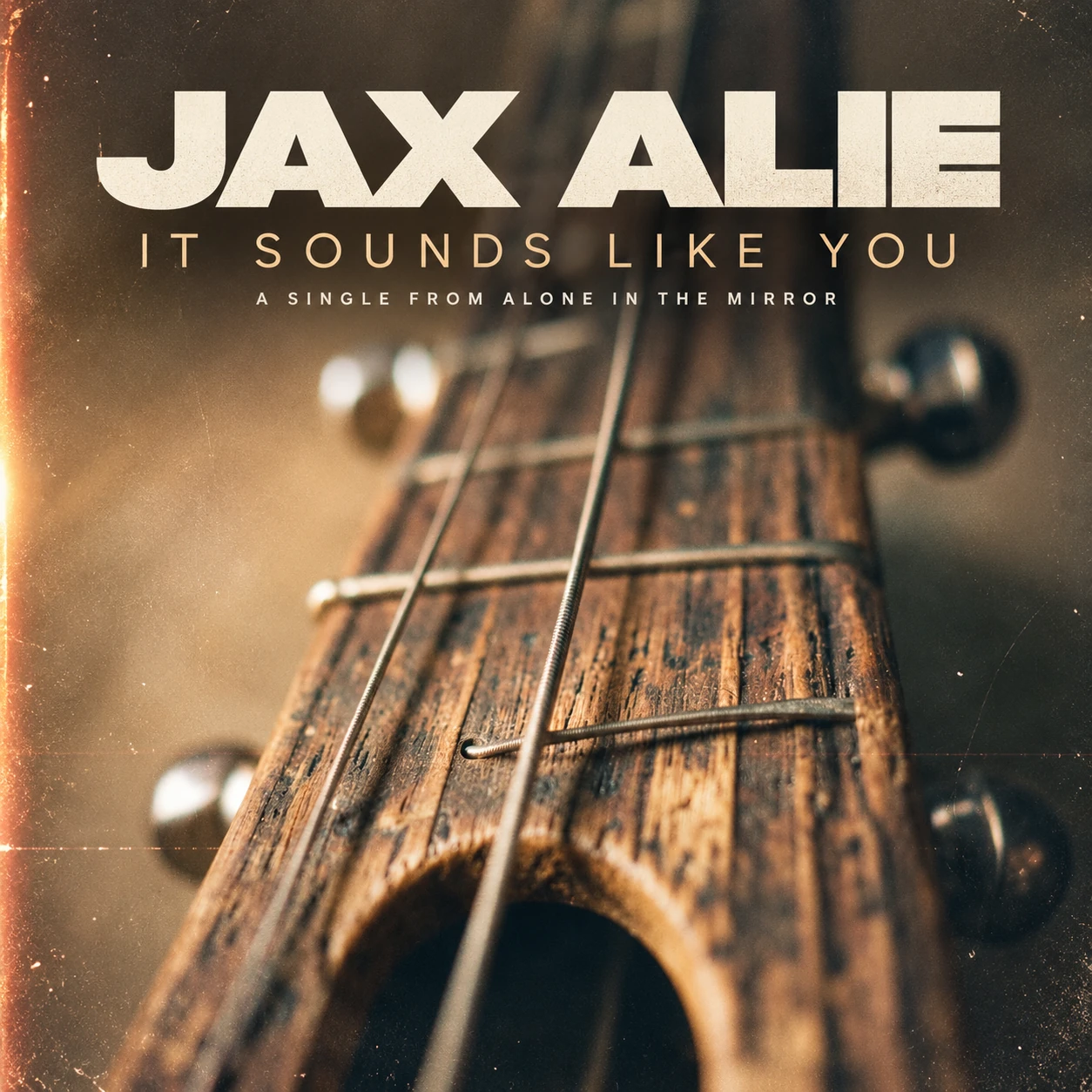 Official single cover for It Sounds Like You by JAX ALIE, showing a close view of strings and a worn wooden instrument